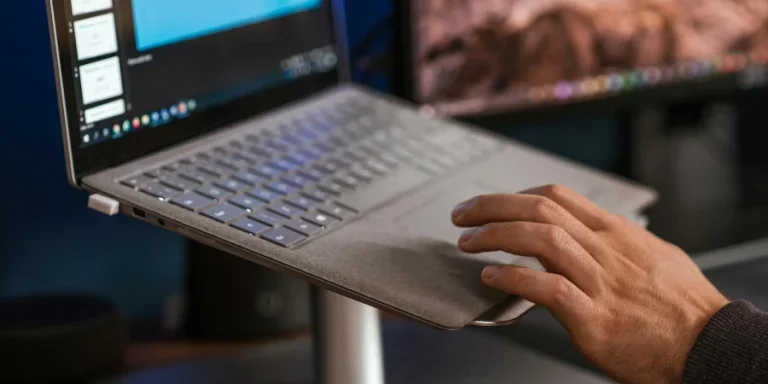 modern netbook and scrolling touchpad placed on stand on desk