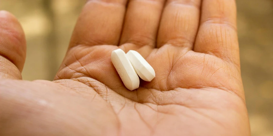 White Medication Pill on Persons Hand