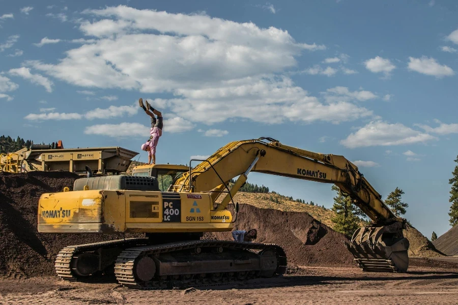 Front Load Loader Beside White Dump Truck