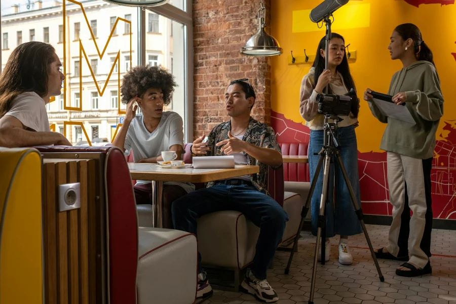 Group of young actors sitting in cafe