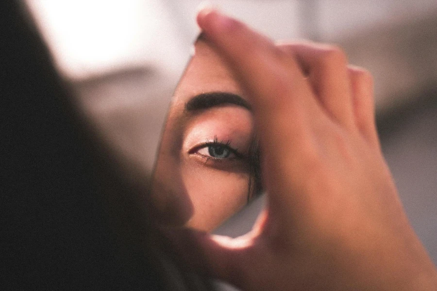 Reflection of Woman's Eye on Broken Mirror 