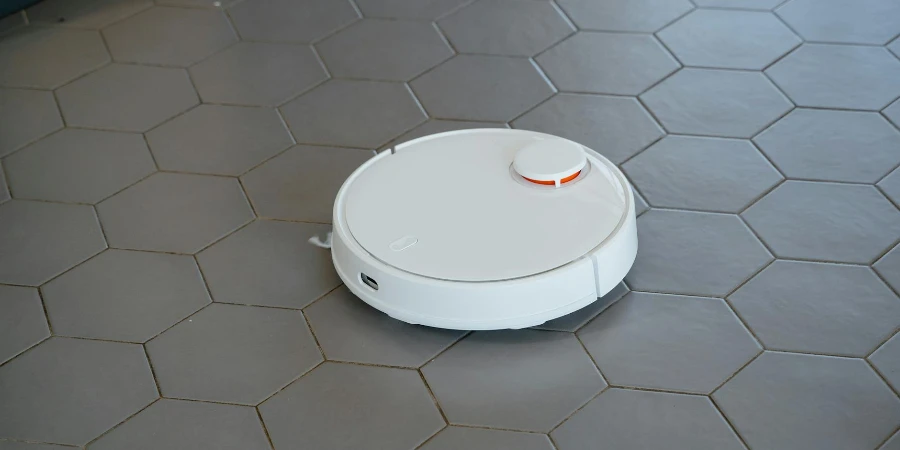 White Round Robot Vacuum on Gray Tiled Floor