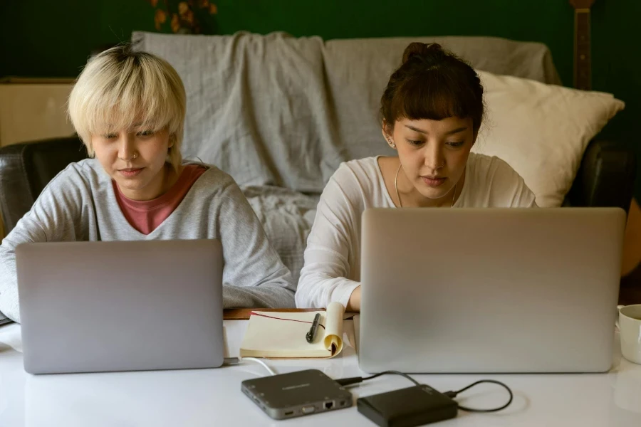 Young ethnic female student surfing internet on laptop