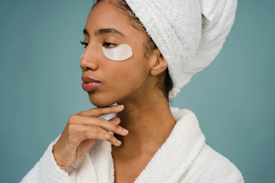 Black woman with eye patches against blue background