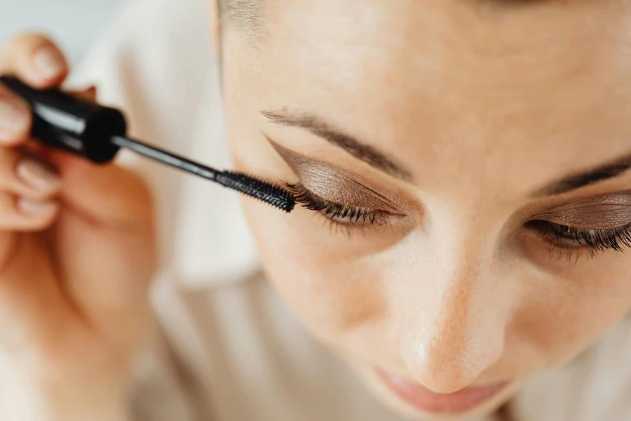 Close-up of a Woman Applying Mascara