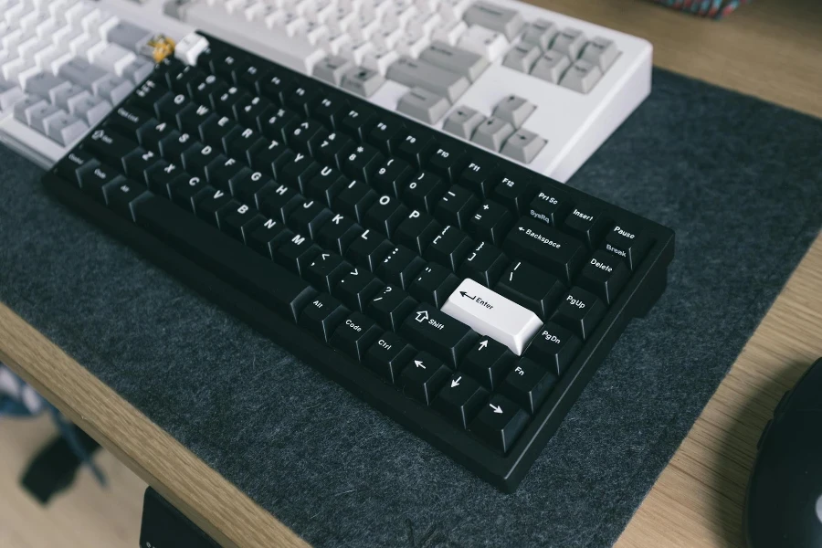 Close-Up Shot of Black and White Keyboards