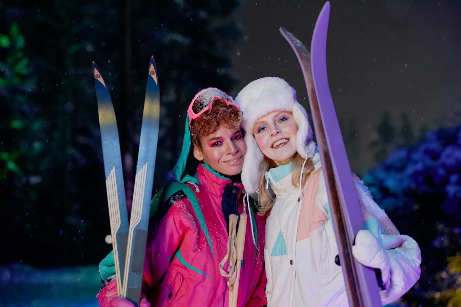 Women Wearing Makeup in Ski Suits Holding Skis