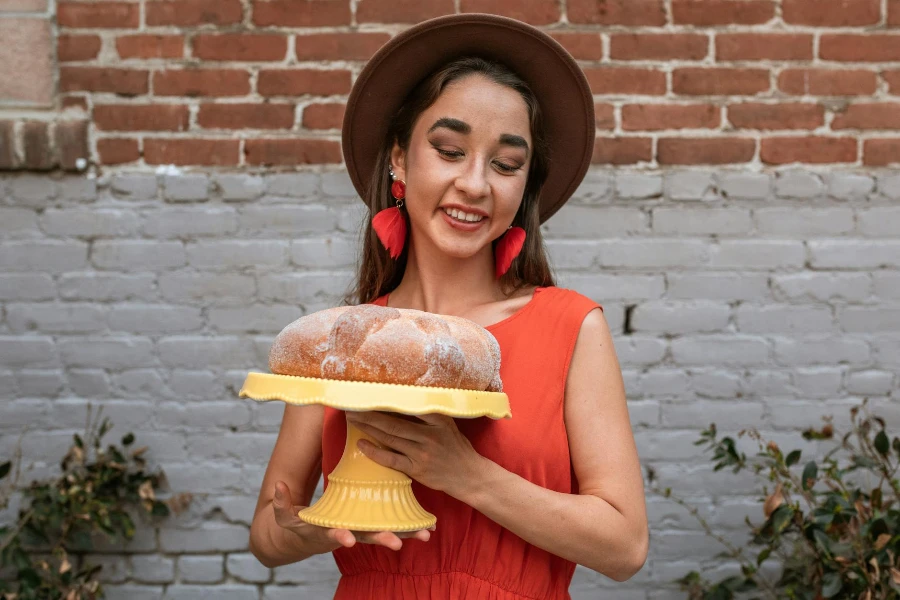 Smiling Woman Holding a Cake Stand