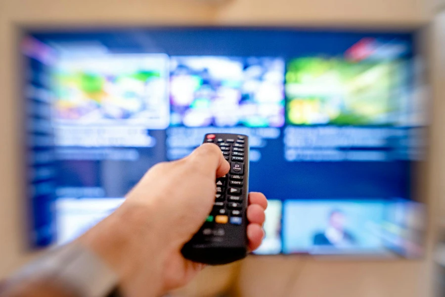 A Close-Up Shot of a Person Using a TV Remote Controller