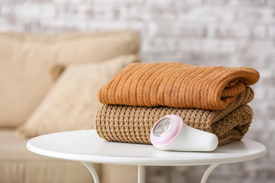 lint remover and clothes on a table