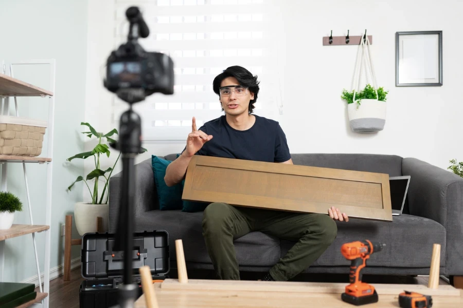 Man filming himself putting together furniture