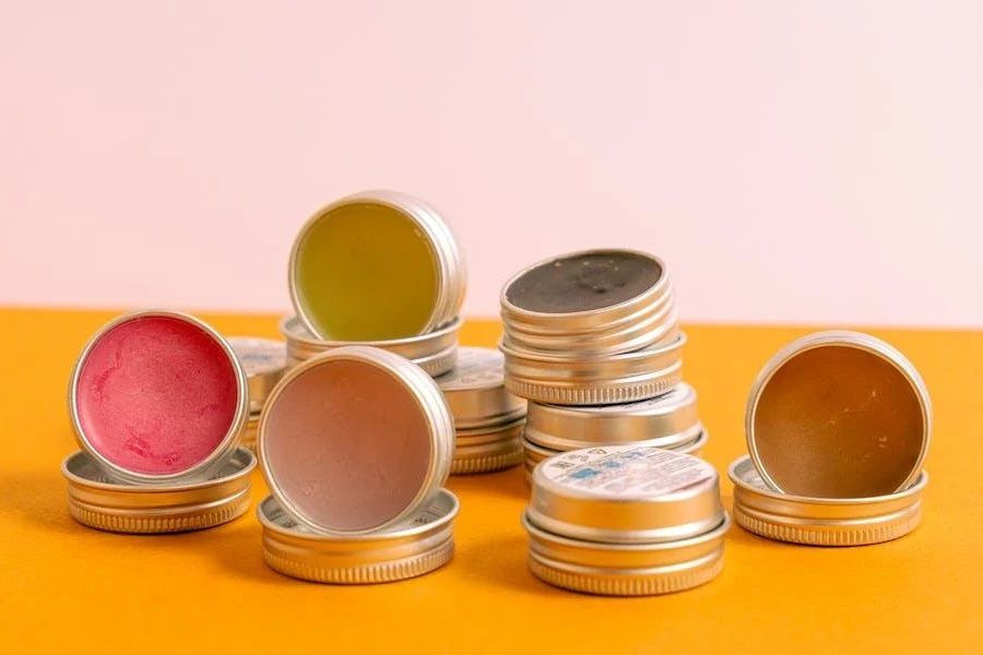 Multiple lip balms arranged on a yellow table