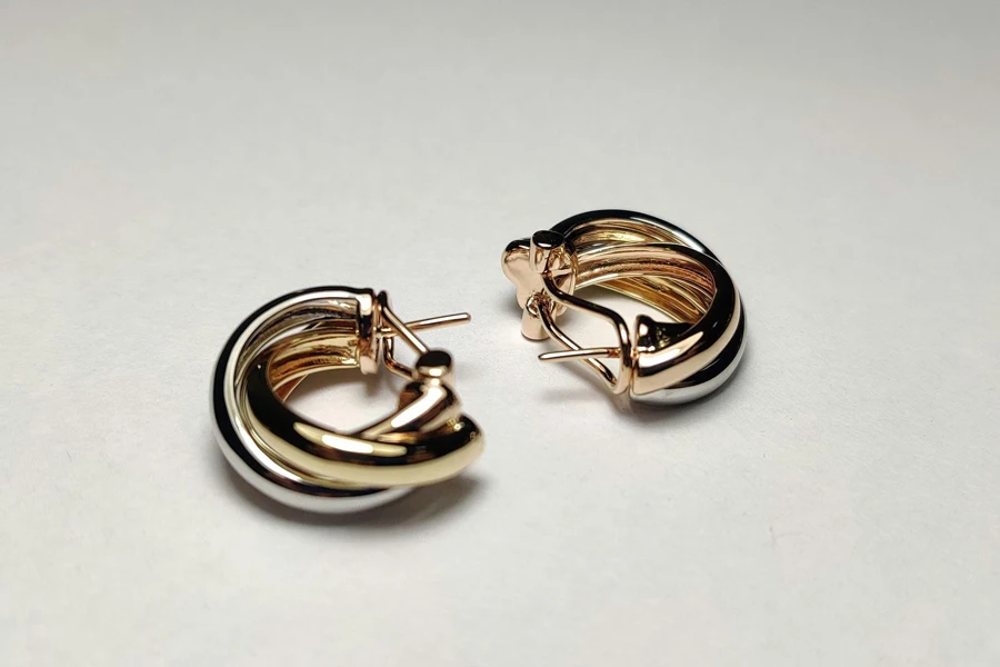 pair of gold huggie earrings.
