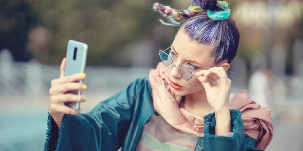 Person in a fashionable outfit taking a selfie