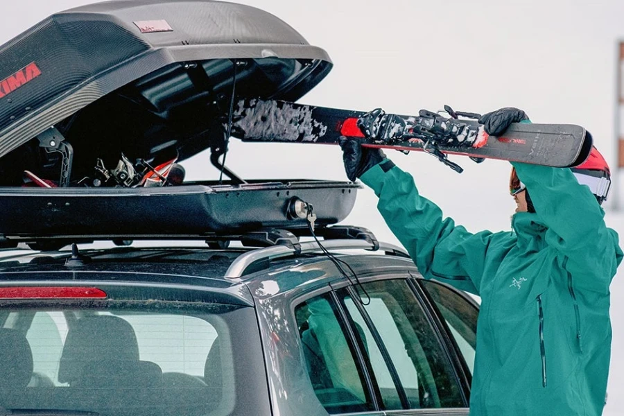 Person loading a rooftop cargo box