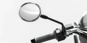 photorealistic image of an electric bike's chrome mirror with a black handlebar and stem