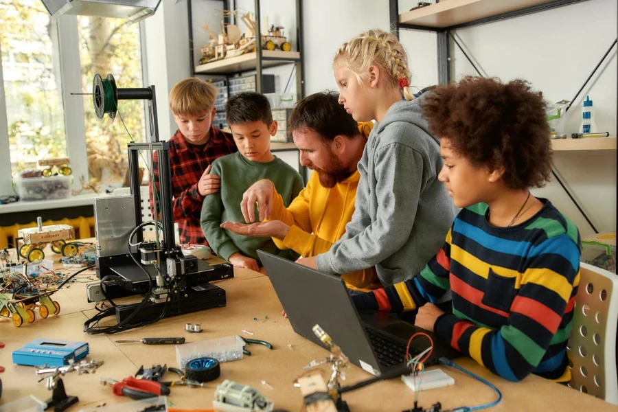 Teacher using 3D printing in the classroom with students