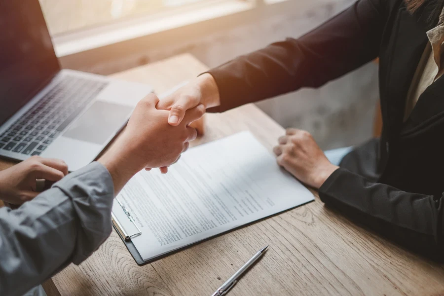 Two businesspeople shake hands after successful transaction