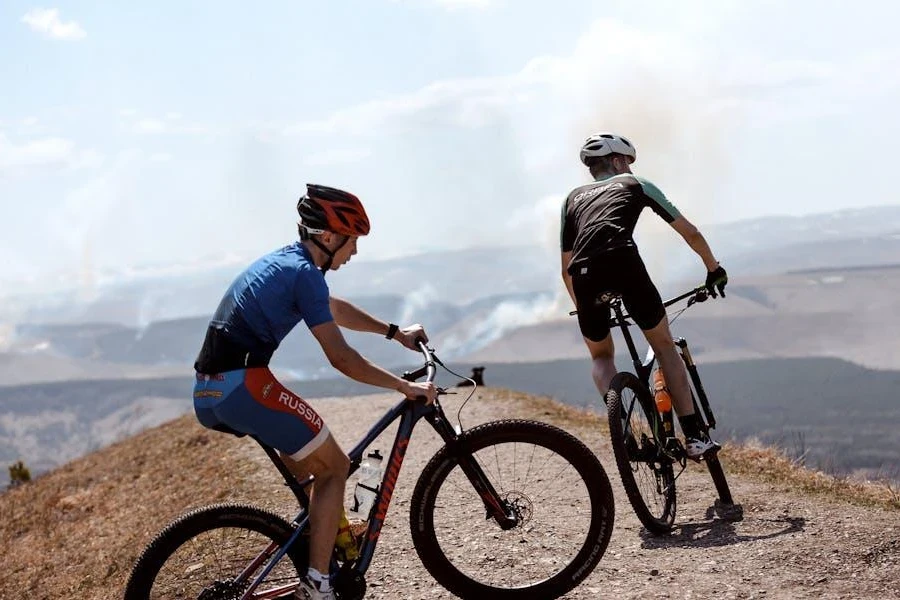 Two men riding on a hill in shorts