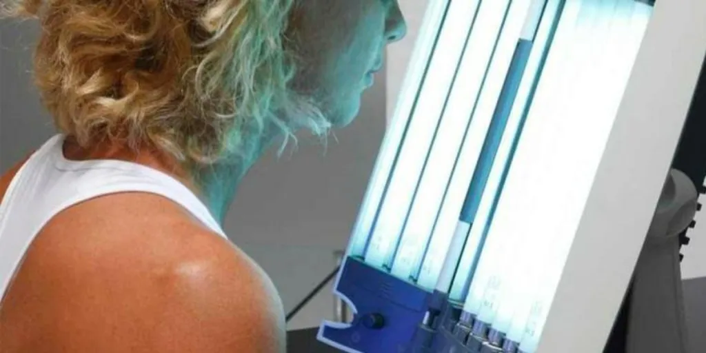 Woman enjoying a bronzing session with a facial tanning machine