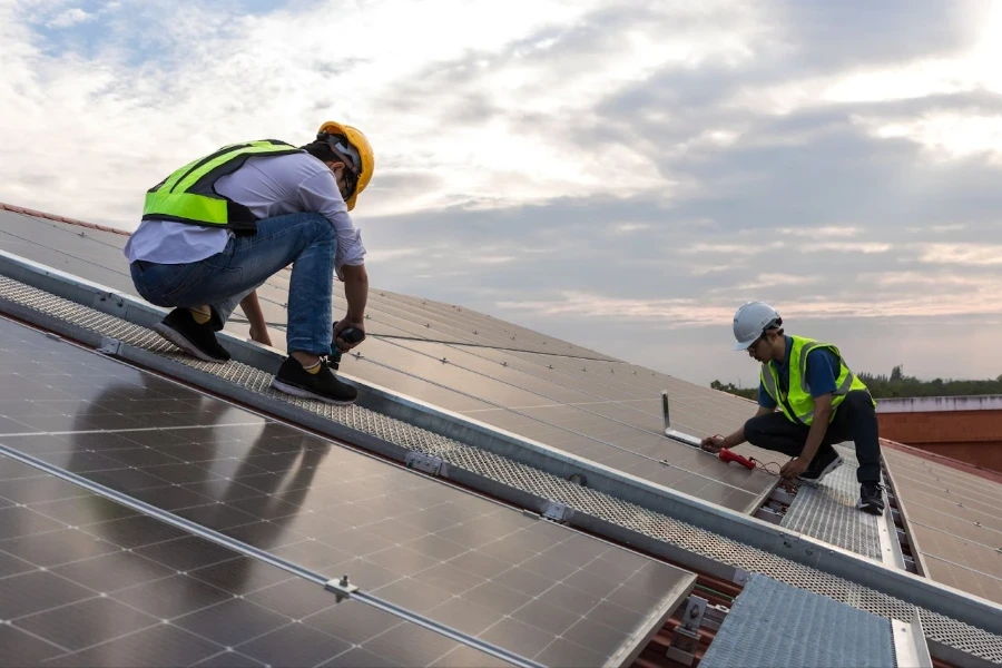 Workers installing solar panels on the roof