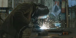A Person Welding at a Workshop