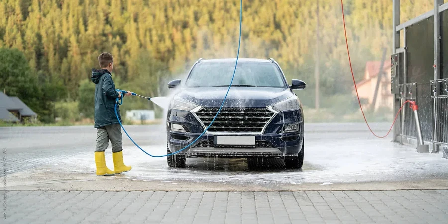 Kid Is Washing Vehicle At Manual Car Wash Station