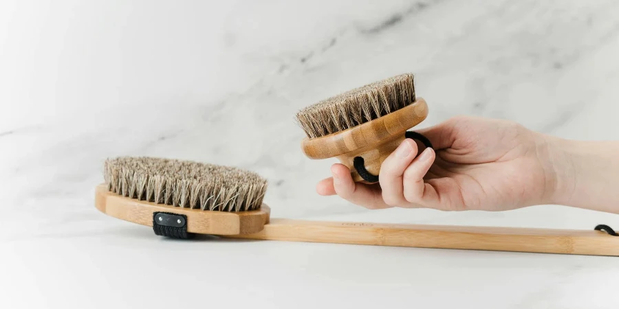 Person Holding Brown Wooden Brush