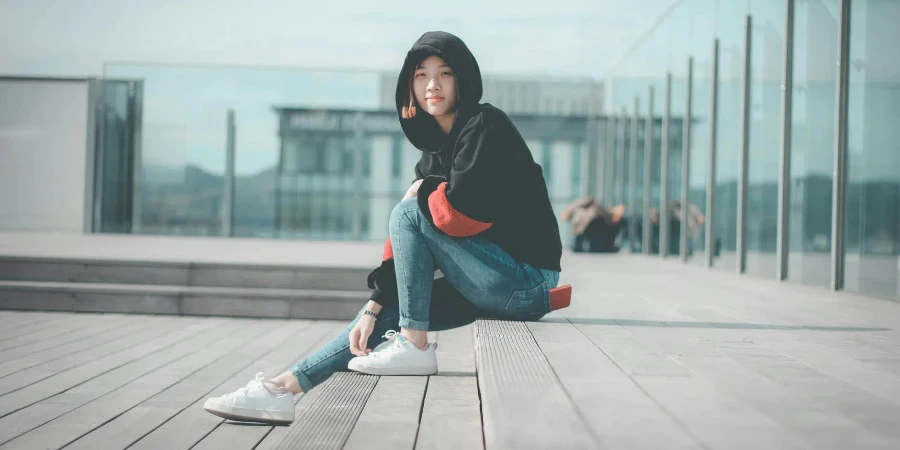 Woman in Black Hoodie Sitting