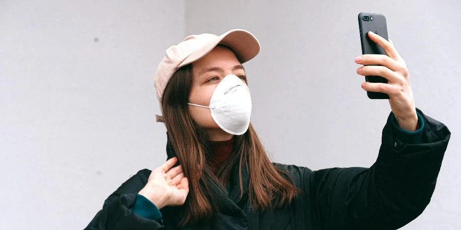 Woman in Face Mask Taking Selfie