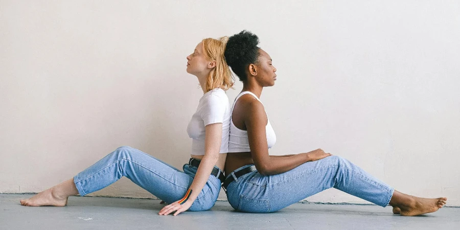 Women Back to Back Sitting on the Floor