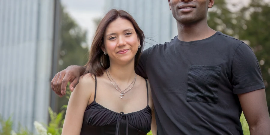 young couple boyfriend and girlfriend smiling together looking at the camera