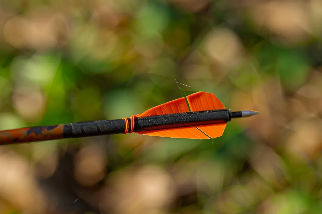 Close up of the tip and fletching on an arrow, focus in detail on black plastic