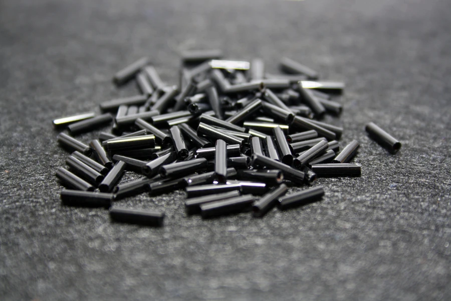 Black beads on a black felt background