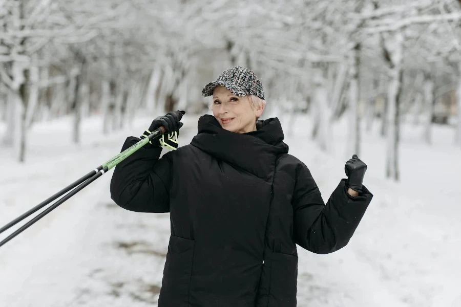 Man in Black Winter Jacket Holding Ski Poles