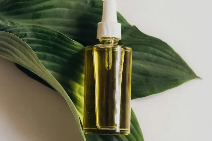 A Bottle of Serum on Green Leaves by PNW Production