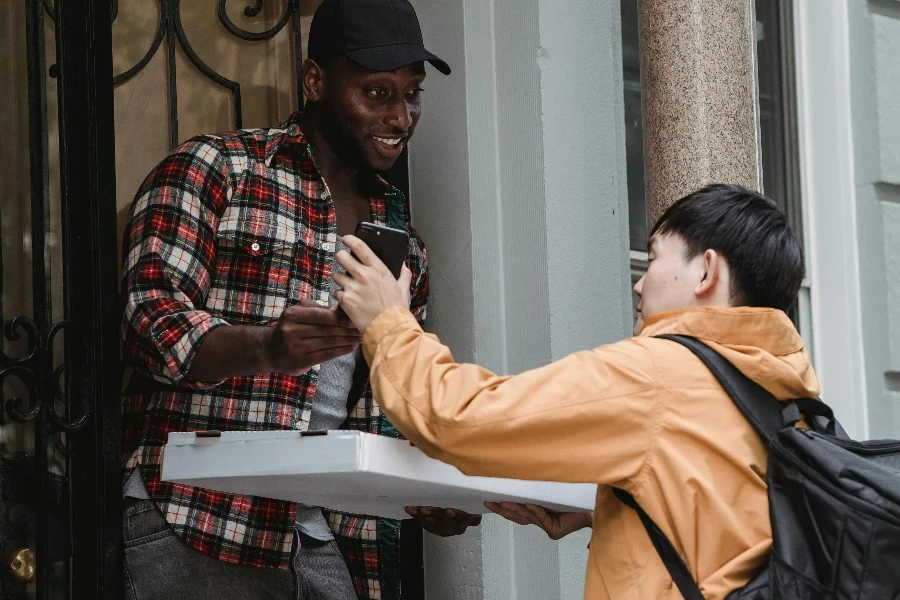 A Man Receiving a Parcel at the Front Door