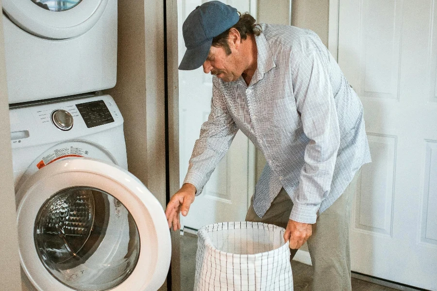 A Man Wearing a Cap Doing Laundry