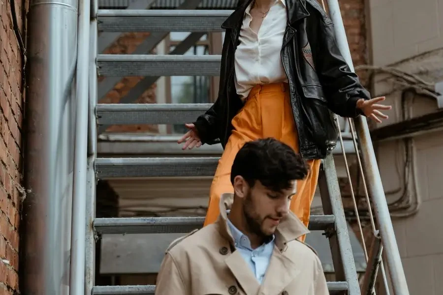 A Man and a Woman Walking Down on Steel Stairs by MART PRODUCTION