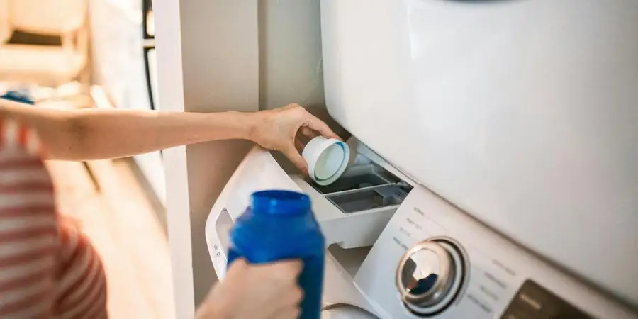 A Person Pouring Detergent in a Washing Machine by RDNE Stock project