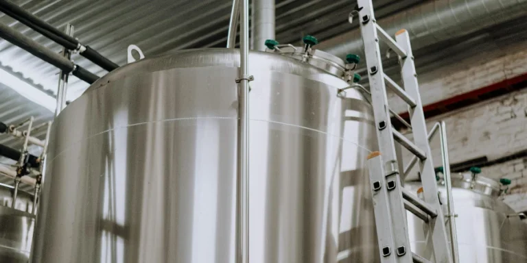 A Steel Ladder Leaning on Stainless Steel Tank