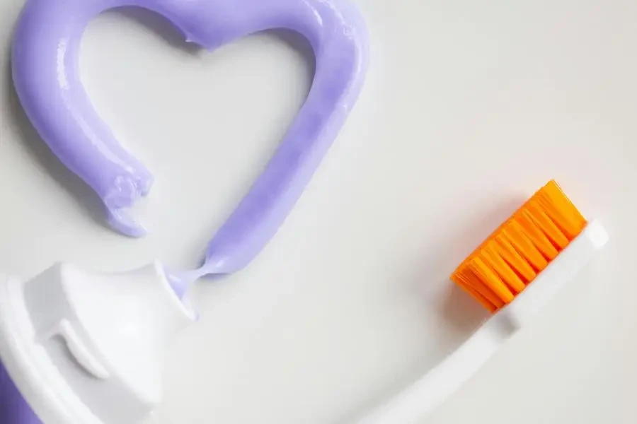 A Toothbrush and Toothpaste on a White Background by Ann Zzz