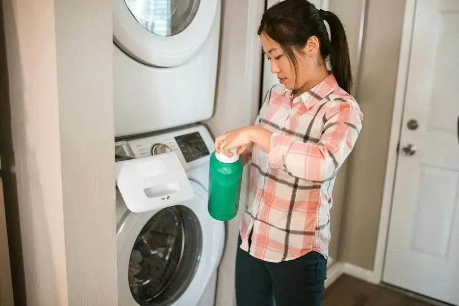 A Woman Holding a Bottle of Detergent by RDNE Stock project