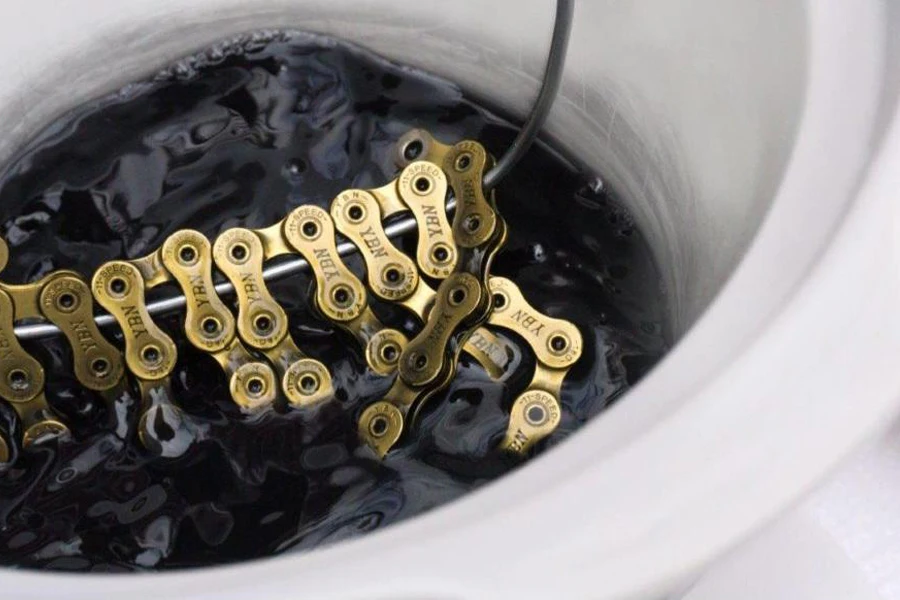 A bike chain immersed in wax lube