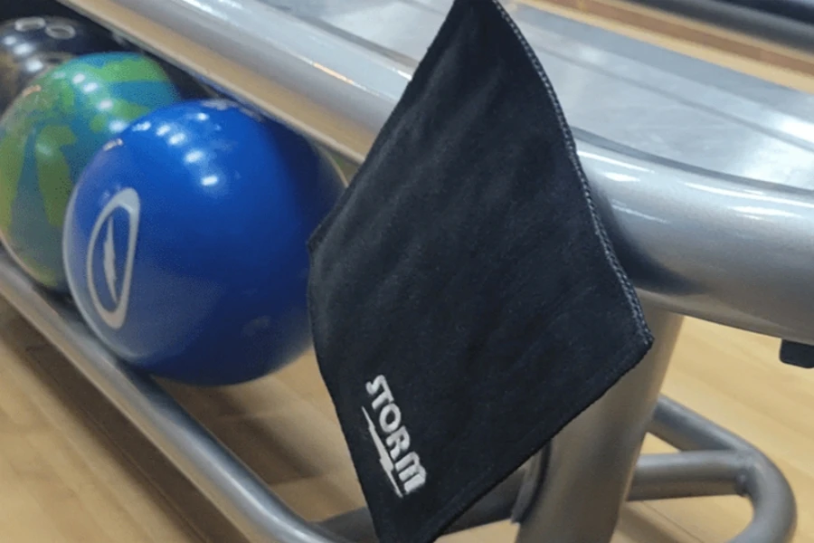 A black shammy towel hanging from a bowling rack