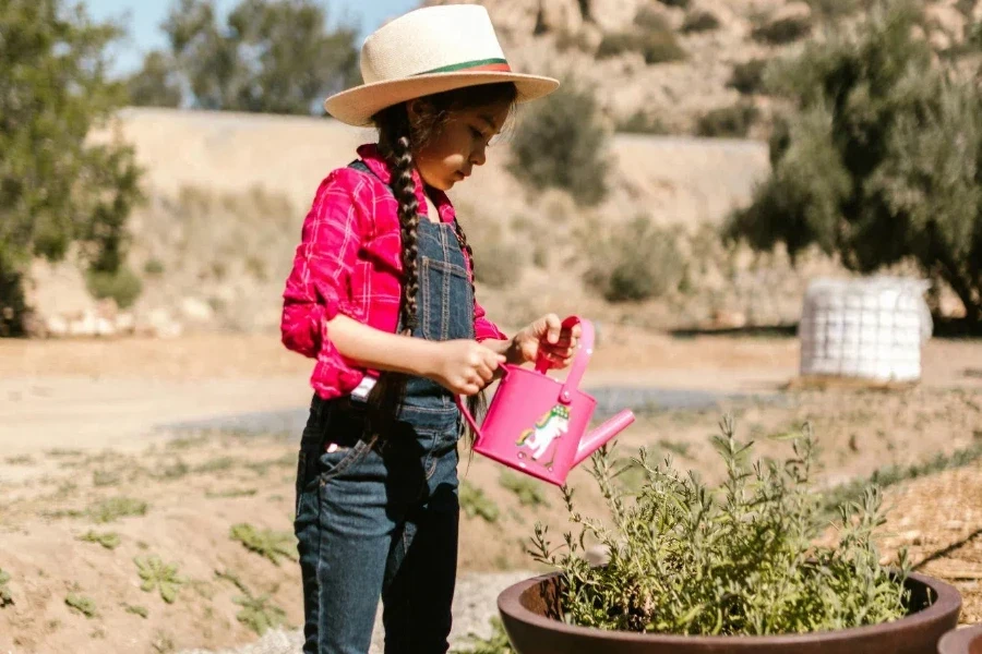 A child in red long sleeves and denim jumper