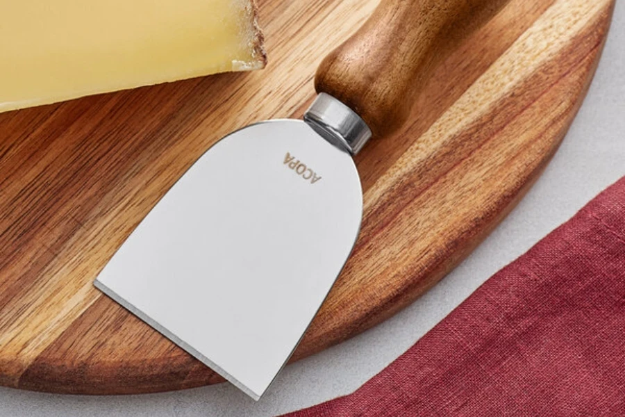 A flat cheese knife on a cheeseboard