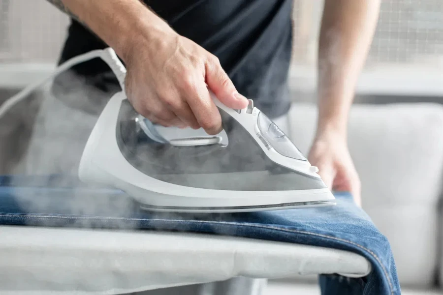 A guy ironing clothes before going outside