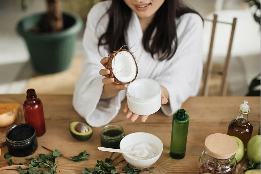 A lot of ingredients for home made cosmetics lying on wooden tabl