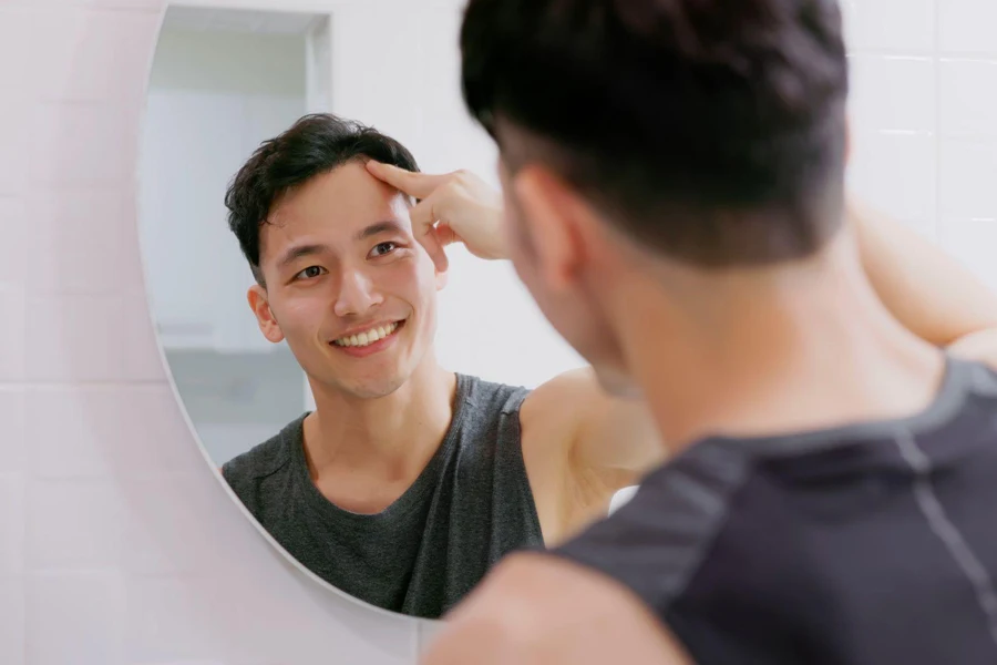 A man smiling at the mirror
